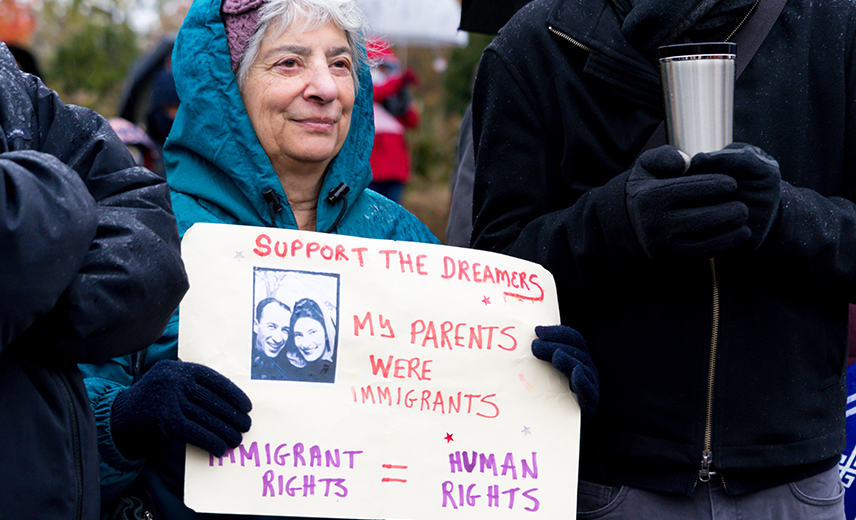 Woman holding sign supporting rights for DREAMers.